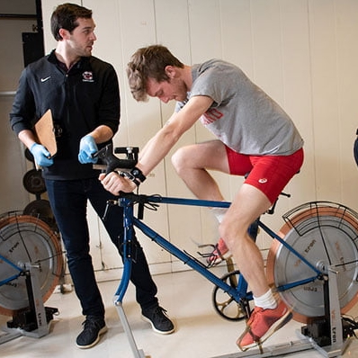 Graduate students in Kinesiology Department tracking data on exercise bike